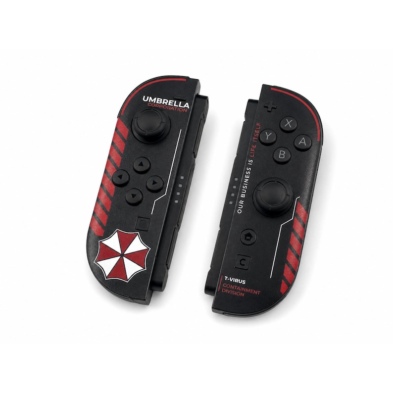 May include: A pair of black video game controllers featuring red diagonal stripes and the Umbrella Corporation logo. The left controller displays the company name, while the right controller includes the text Our Business Is Life Itself and T-Virus Containment Division alongside standard buttons and joysticks.