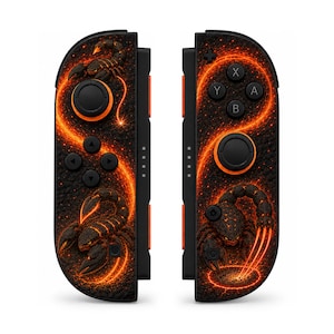 May include: A pair of black video game controllers featuring a vibrant orange and red scorpion graphic design. The controllers include black analog sticks with orange rings, directional buttons, and standard action buttons on a textured surface.