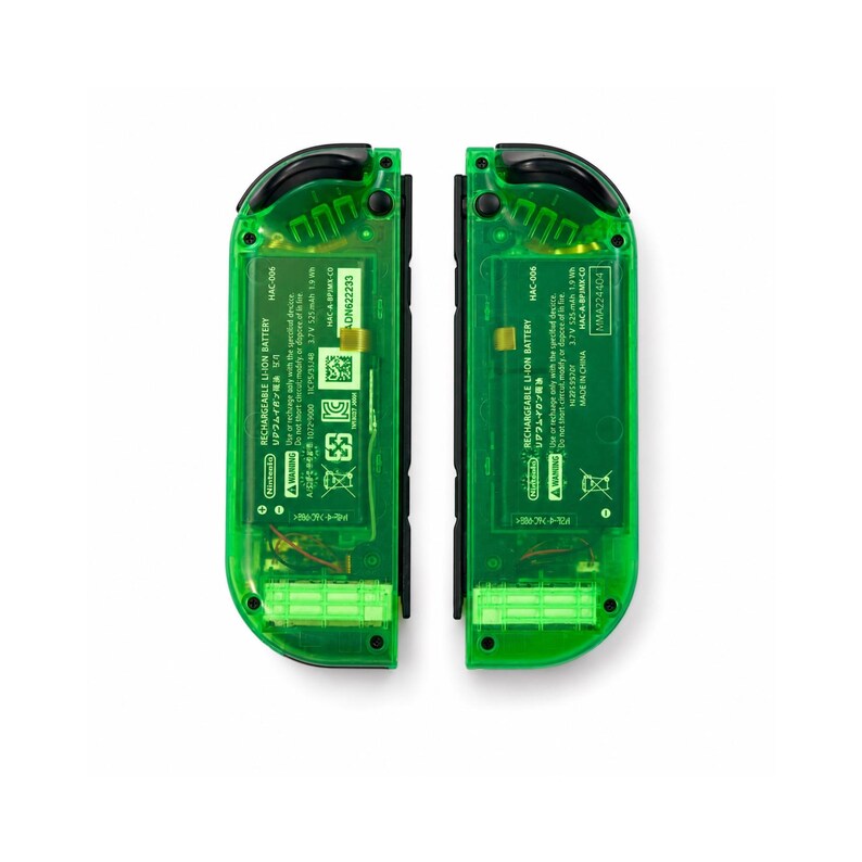 May include: Two transparent green game controller Joy-Cons. Each controller has black buttons and a black rail. The internal components are visible through the green plastic. Text on the controllers includes "RECHARGEABLE LI-ION BATTERY" and "HAC-006".