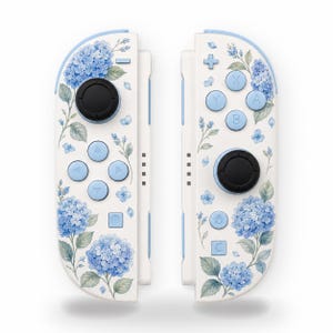 May include: A pair of white game controllers featuring a blue hydrangea floral pattern. The left controller has a black joystick and blue directional buttons, while the right controller has a black joystick and blue A, B, X, and Y action buttons.