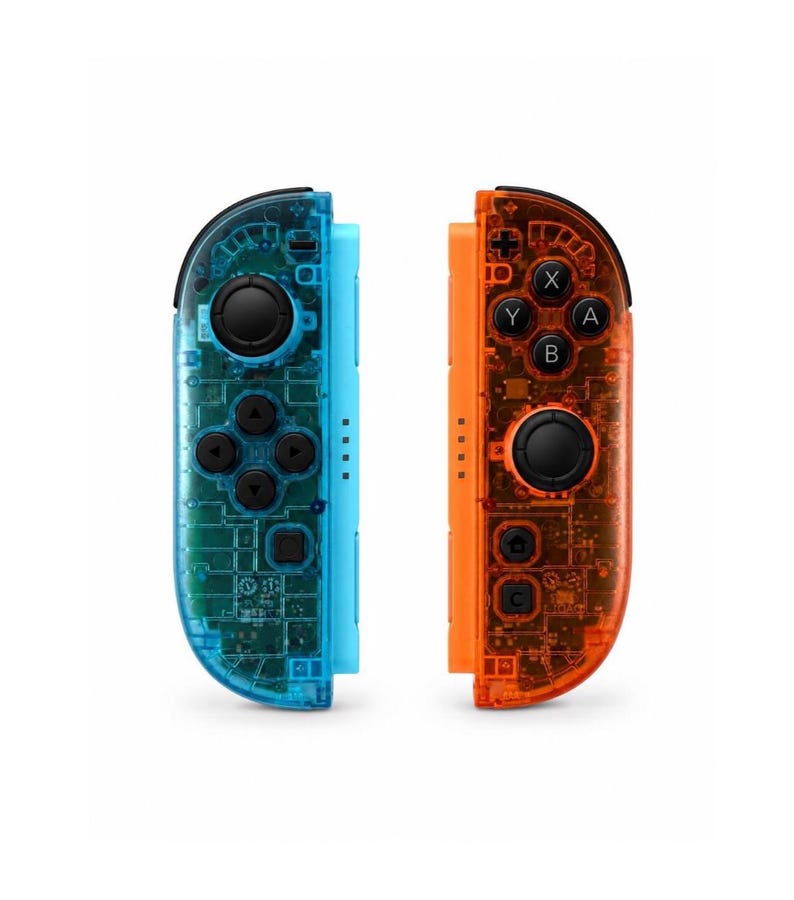 May include: A pair of wireless game controllers featuring a translucent blue shell on the left and a translucent orange shell on the right. Both controllers include black analog sticks, directional buttons, and action buttons labeled A, B, X, and Y.