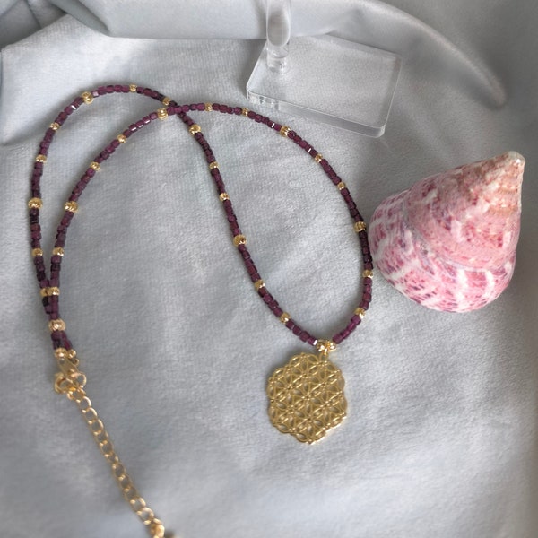 Necklace with pendant. Earrings. Almandine Garnet. Black Spinel. Brass. Sacred symbol "Flower of Life."