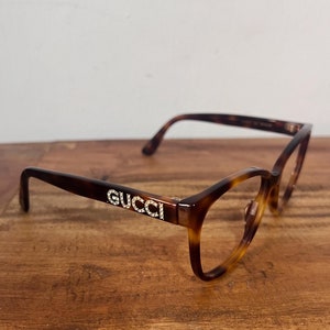 Gucci wood frame glasses top