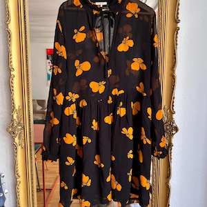 ganni dress black orange Ganni black wrap dress with orange floral details StyleSwap