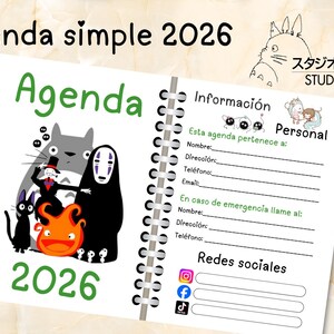 May include: A spiral-bound 2026 agenda with a white cover featuring illustrations of characters from Studio Ghibli films. The cover includes the text "Agenda" in green and "2026" in green. The agenda includes personal information sections.