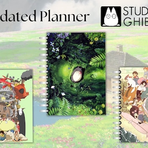 May include: Three undated planners featuring Studio Ghibli characters. The first planner has a green background with Totoro sleeping in a tree. The second planner has a light green background with a scene from Howl's Moving Castle. The third planner has a light brown background with a scene from My Neighbor Totoro.