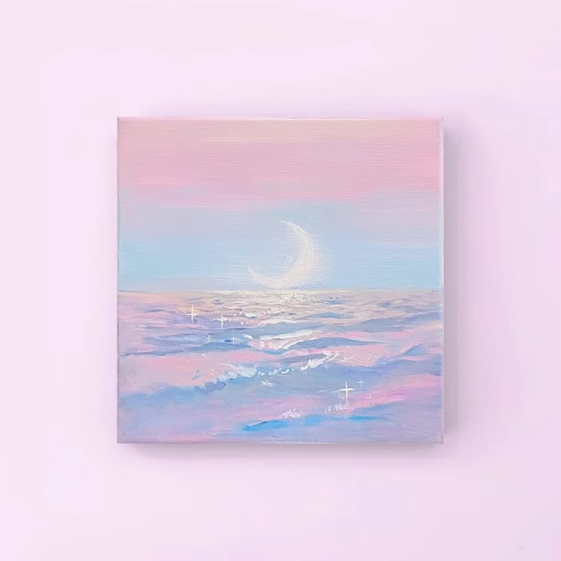 May include: A painting of a crescent moon over a sea of pastel pink, blue, and purple waves. The sky is a gradient of pink and blue, and there are small white stars scattered throughout the painting.