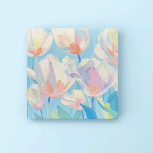 May include: A painting of pastel pink, white, and blue tulips on a light blue background.