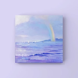 May include: A painting of a seascape with a rainbow over the water.  Sailboats are in the distance and the water is a light purple color.