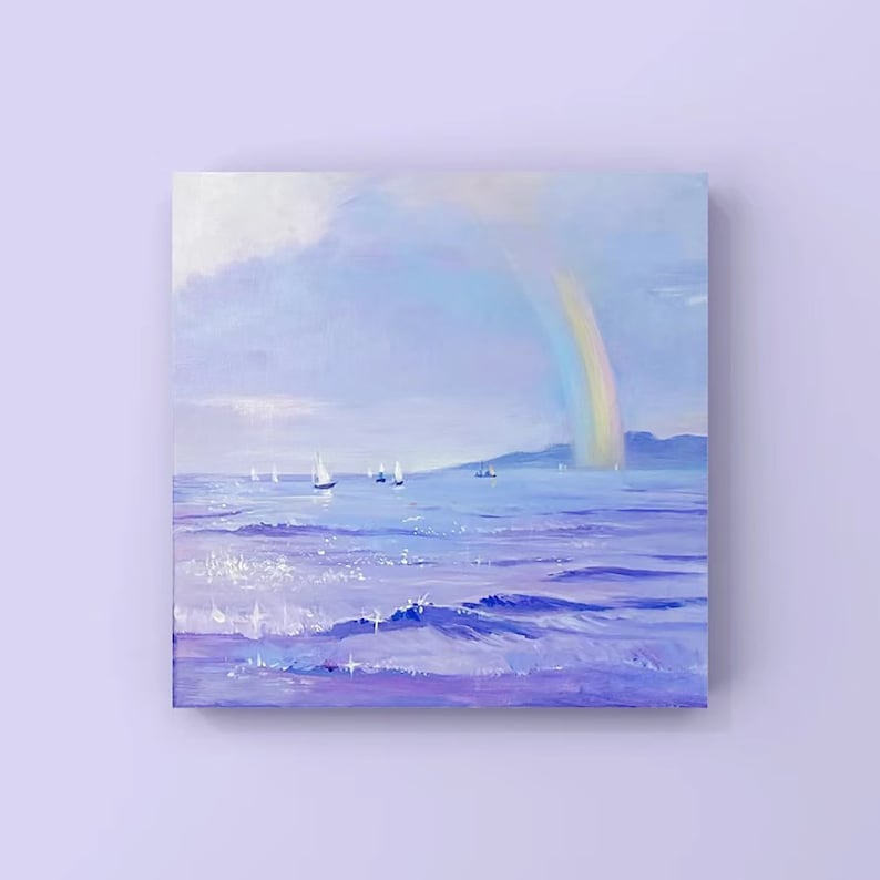 May include: A painting of a seascape with a rainbow over the water.  Sailboats are in the distance and the water is a light purple color.