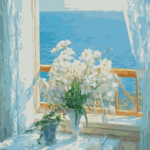 May include: A bouquet of white flowers in a white vase sits on a white tablecloth in front of a window with a view of the ocean. The window is open and the curtains are drawn back.