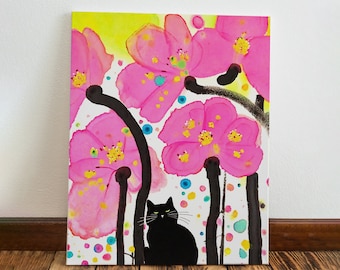 May include: A canvas art print featuring a black cat sitting beneath large pink flowers with yellow centers and black stems. The background is white with colorful polka dots and a yellow gradient.