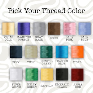 May include: Image displaying a color chart with thread samples. The text "Pick Your Thread Color" is at the top. Colors include Vegas Gold, Majestic Purple, Gray Haze, Sienna, Baby Pink, Baby Blue, Navy, Tusk, Hunter Green, Peacock Blue, Tiger, Super White, Kelly Green, Saffron, Emerald Black, and Apple Red.