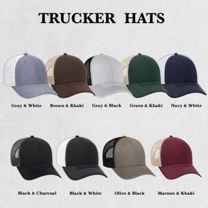 May include: A collection of trucker hats in various colors, including gray, brown, black, green, and navy. Each hat features a mesh back and a solid front panel. The text "TRUCKER HATS" is displayed at the top, with color combinations labeled below each hat.