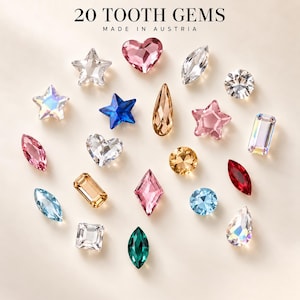 Könnte beinhalten: Ein Set aus 20 Zahnschmucksteinen, hergestellt in Österreich, in verschiedenen Formen wie Sternen, Herzen, Tropfen, Kreisen, Rechtecken und Marquise-Schliffen in Farben wie Transparent, Rosa, Blau, Grün, Rot und Bernstein mit irisierendem Glanz.