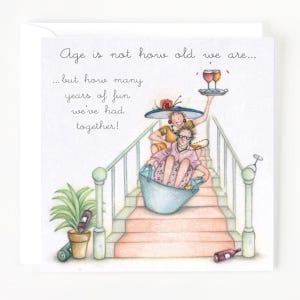 May include: A greeting card featuring an illustration of three women riding down a staircase in a bucket. The card reads "Age is not how old we are... but how many years of fun we've had together!"