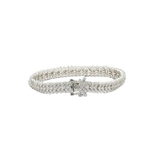 May include: A silver tennis bracelet with a double row of pave set diamonds.