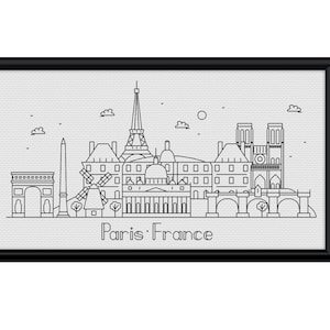 May include: Black framed print with a minimalist line drawing of the Paris skyline. The artwork includes the Eiffel Tower, Arc de Triomphe, Notre Dame, and the text "Paris France".