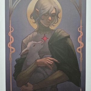 May include: A digital illustration of a person with long silver hair and pointed ears holding a white lamb. The person is wearing a white shirt with a red diamond on the chest and a green cloak. The background is a dark blue with a gold frame.