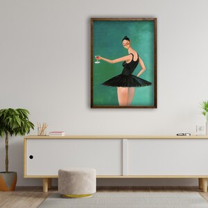 May include: A framed painting of a woman in a black tutu holding a glass of red wine. The background is a teal green color.