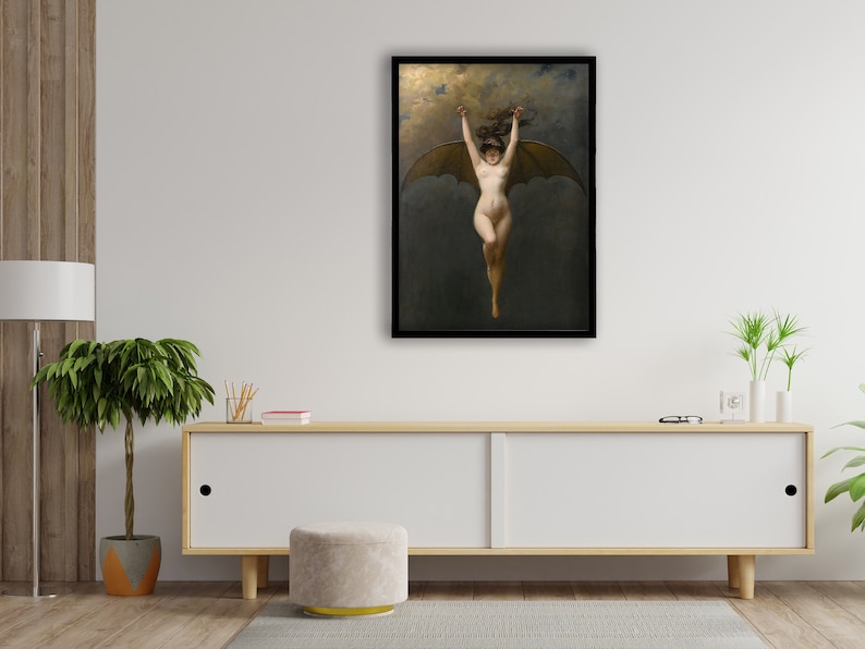 May include: A framed print of a classical painting depicting a nude figure with bat-like wings, arms raised, against a dark, cloudy background. The artwork is displayed in a black frame, adding a touch of elegance to the piece.