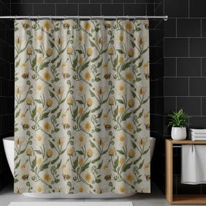 May include: A beige shower curtain with a repeating pattern of white daisies, yellow flowers, butterflies, and bees. Green leaves and stems intertwine throughout the design. The curtain is hanging in a bathroom with black tile.