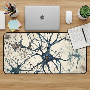 May include: A rectangular mouse pad with a neural network design in shades of blue and gold against a cream background. The pad is surrounded by office supplies, including a laptop, mouse, and notepad.