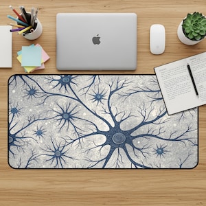 May include: A rectangular mouse pad with a detailed blue neuron design against a speckled gray background. The design features branching structures and circular cell bodies. The mouse pad is on a wooden desk with office supplies.
