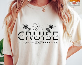 May include: Cream-colored t-shirt with a black graphic design that reads "CRUISE" with palm trees, sun, and waves, and the text "MAKING MEMORIES TOGETHER 2025". The shirt is a relaxed fit.