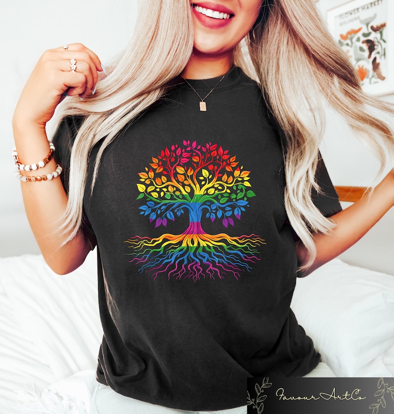 May include: Black t-shirt featuring a colorful tree design with rainbow-colored leaves, trunk, and roots. The tree graphic is centered on the shirt. The shirt is a crew neck style.