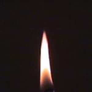 May include: A single flame burning brightly against a black background.
