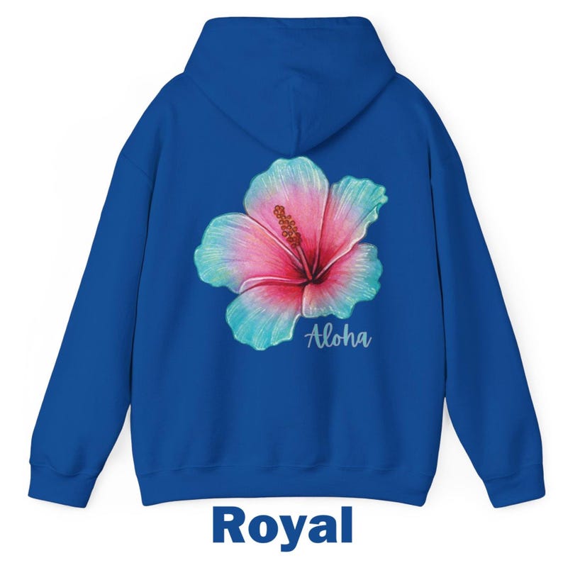 May include: A royal blue hooded sweatshirt featuring a large hibiscus flower graphic on the back. The flower has pink and teal petals with a yellow stamen. The word Aloha is printed in a white script font below the flower. The text Royal is below.