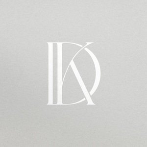 May include: A minimalist logo design featuring the intertwined letters "DK" in a clean, white font. The letters are set against a light gray textured background, creating a simple yet elegant visual.