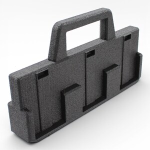 May include: A textured black plastic carrying case with a handle. The case has a rectangular shape with several recessed slots and a handle at the top for easy carrying. The surface has a slightly rough texture.
