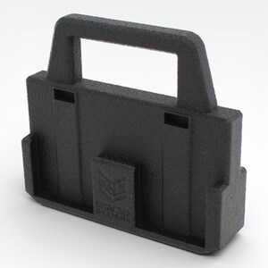 May include: A textured black 3D-printed object with a handle and a rectangular base. The object has a handle at the top and a small rectangular section on the front with the text "BGV3D Designs".