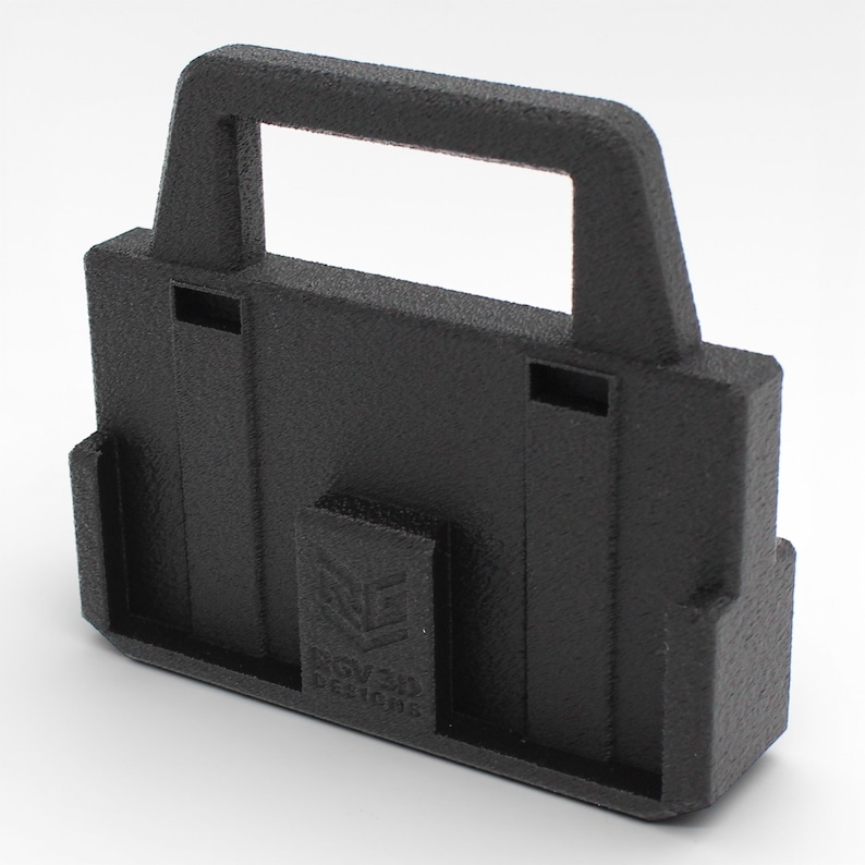 May include: A textured black 3D-printed object with a handle and a rectangular base. The object has a handle at the top and a small rectangular section on the front with the text "BGV3D Designs".