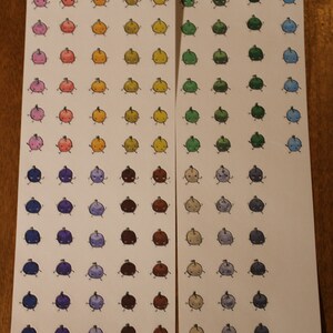 May include: Two sheets of white paper with rows of colourful cartoon characters. The characters are all the same shape, but have different colours and facial expressions. The characters are arranged in rows of 8, with 8 rows on each sheet.