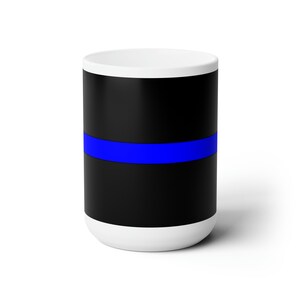 May include: White ceramic mug with a black background and a thin blue stripe across the center.