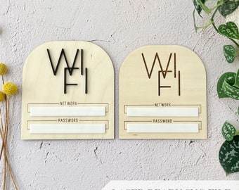 May include: Two wooden signs with a rounded top, each with the word "WIFI" in black lettering. Each sign has two blank spaces for writing in network and password information. The signs are laser cut and ready to be used.