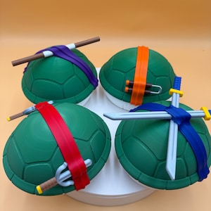 May include: A white ceramic mug with a black handle and the text "But First, Coffee" in a black, bold font. The mug is on a white surface.