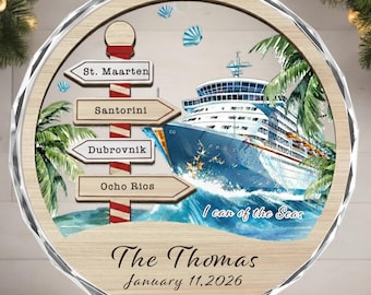 May include: A round Christmas ornament with a cruise ship design. The ornament features a wooden background with a cruise ship, palm trees, and directional signs pointing to St. Maarten, Santorini, Dubrovnik, and Ocho Rios. The text "I can of the Seas", "The Thomas", and the date January 11, 2026 are also included.