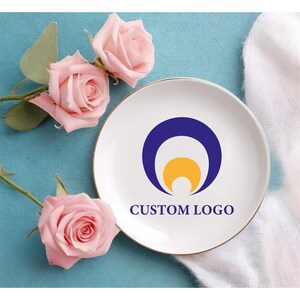 May include: A set of three ceramic mugs with a speckled, matte finish. The mugs are in shades of cream, light gray, and dark gray. Each mug has a simple, minimalist design, perfect for coffee or tea.