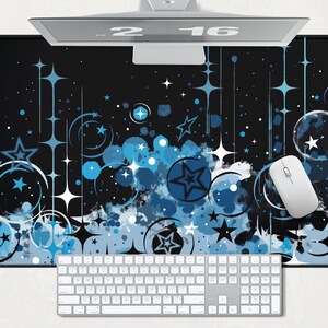 May include: A black and blue mouse pad with a starry night design. The design features white stars, blue circles, and blue swirls. The mouse pad is rectangular and has a smooth surface.