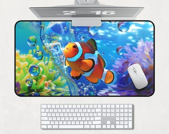 May include: A colorful mousepad with an orange and white clownfish swimming through blue water with bubbles. The mousepad has a black border.