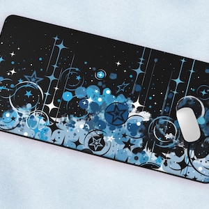 May include: A black phone case with a blue and white abstract design featuring stars, circles, and swirls.