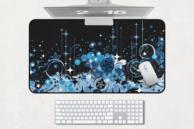 May include: A black and blue mouse pad with a design of stars, circles, and swirls. The mouse pad is on a white surface with a keyboard and a computer mouse.