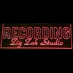 May include: A red neon sign with the words "RECORDING Zig Zak Studio" on a black background.