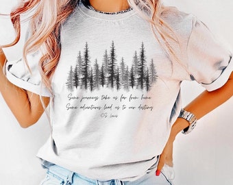 May include: White t-shirt with a black silhouette of a forest and the quote "Some journeys take us far from home. Some adventures lead us to our destiny. - C.S. Lewis"