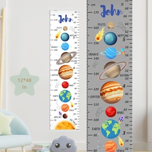 May include: A height chart featuring a colorful solar system design with planets and measurements in inches and centimeters. The chart includes the name "John" in blue script and is approximately 12 x 48 inches.