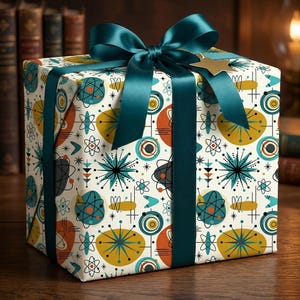 May include: A wrapped gift box with a teal satin ribbon and bow. The wrapping paper has a mid-century modern atomic design in teal, orange, yellow, and black on a cream background. A gold star-shaped tag is attached to the bow.